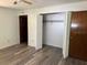 Neutral primary bedroom with new floors, closet, and access to main hallway at 4701 Ne 9Th St, Ocala, FL 34470