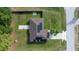 Aerial view of home showcasing roof with solar panels, fenced-in backyard, and well-manicured lawn at 51 Pine Trace Loop, Ocala, FL 34472