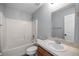 Bathroom with a shower over tub, a large mirror, and light walls at 51 Pine Trace Loop, Ocala, FL 34472