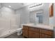 Bathroom with a shower over tub and a vanity with wood cabinets at 51 Pine Trace Loop, Ocala, FL 34472