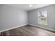 Bedroom with wood-look floors, a ceiling fan, and a window at 51 Pine Trace Loop, Ocala, FL 34472