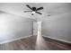 Cozy bedroom features wood-look floors and a ceiling fan at 51 Pine Trace Loop, Ocala, FL 34472