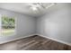 Bedroom with a window and wood-look floors at 51 Pine Trace Loop, Ocala, FL 34472