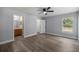 Bedroom with wood-look floors connecting to an ensuite bathroom and walk-in closet at 51 Pine Trace Loop, Ocala, FL 34472