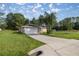 Charming single-Gathering home with a spacious driveway and a well-maintained front lawn and attached two-car garage at 51 Pine Trace Loop, Ocala, FL 34472