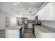 Kitchen features stainless steel appliances, granite countertops, and stylish white cabinets at 51 Pine Trace Loop, Ocala, FL 34472