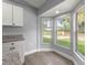 Bright eat-in kitchen featuring granite countertops, modern white cabinets and plenty of natural light at 51 Pine Trace Loop, Ocala, FL 34472