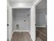 Bright laundry room with gray walls, wood floors, wire shelf, and washer and dryer hookups at 51 Pine Trace Loop, Ocala, FL 34472