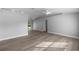 Spacious living room with light gray walls, wood-look floors, and ample natural light at 51 Pine Trace Loop, Ocala, FL 34472