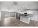Bright, open-concept space featuring wood flooring, stainless steel appliances, an island, and gray walls at 51 Pine Trace Loop, Ocala, FL 34472