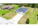 Aerial view of a modern home featuring a two-car garage, long driveway and green lawn at 5239 Sw 114Th Street Rd, Ocala, FL 34476