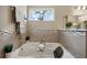 Bathroom highlighting the soaking tub with tile accents and a decorative window at 5239 Sw 114Th Street Rd, Ocala, FL 34476