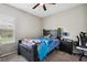 Cozy bedroom features a dark wood bed frame, bedside table, and window view at 5239 Sw 114Th Street Rd, Ocala, FL 34476