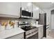 Modern kitchen features stainless steel appliances and light gray cabinets at 5239 Sw 114Th Street Rd, Ocala, FL 34476
