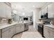 Open kitchen with stainless steel appliances, breakfast bar, and view to living area at 5239 Sw 114Th Street Rd, Ocala, FL 34476