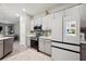 Bright kitchen with stainless steel appliances and modern gray cabinetry at 5239 Sw 114Th Street Rd, Ocala, FL 34476
