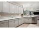 Contemporary kitchen with stainless steel appliances and stylish gray cabinetry at 5239 Sw 114Th Street Rd, Ocala, FL 34476