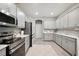 Bright kitchen with stainless steel appliances, light gray cabinets, and wood-look flooring at 5239 Sw 114Th Street Rd, Ocala, FL 34476
