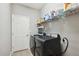 Well-lit laundry room featuring a modern washer and dryer set and ample shelving for storage at 5239 Sw 114Th Street Rd, Ocala, FL 34476