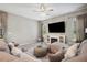 Spacious living room featuring a large television and a cozy sectional sofa at 5239 Sw 114Th Street Rd, Ocala, FL 34476