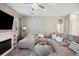 Comfortable living room with an elegant fireplace and large sectional sofa at 5239 Sw 114Th Street Rd, Ocala, FL 34476