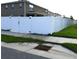 White vinyl fence enclosing the back yard is accessible through a gate at 5962 Sw 80Th Ln, Ocala, FL 34476
