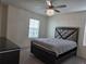 Well-lit bedroom featuring a fan, dresser, and natural light at 5962 Sw 80Th Ln, Ocala, FL 34476