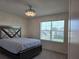 Inviting bedroom with large window, ceiling fan, and plush carpet at 5962 Sw 80Th Ln, Ocala, FL 34476