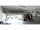 A spacious garage with epoxy floors is equipped with storage solutions and space for multiple cars at 5962 Sw 80Th Ln, Ocala, FL 34476