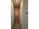 Hallway featuring tile flooring, light-colored walls and trim, with doors leading to bedrooms at 5962 Sw 80Th Ln, Ocala, FL 34476