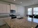 Kitchen features granite countertops, white cabinets, and stainless steel appliances at 5962 Sw 80Th Ln, Ocala, FL 34476