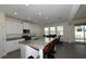 Bright kitchen featuring modern appliances, granite counters, barstool seating, and backyard access at 5962 Sw 80Th Ln, Ocala, FL 34476