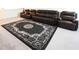 Spacious living room showcasing a black rug and plush brown sofa at 5962 Sw 80Th Ln, Ocala, FL 34476