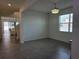 Bright living room with tile flooring, window views, and decorative light fixture at 5962 Sw 80Th Ln, Ocala, FL 34476