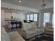 Spacious living room open to kitchen with sleek bar stools and comfortable seating at 5962 Sw 80Th Ln, Ocala, FL 34476