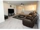 Cozy living room with a plush brown sofa, plush carpet, and a chandelier at 5962 Sw 80Th Ln, Ocala, FL 34476