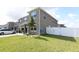Side yard featuring a healthy lawn, young tree, and white vinyl fence providing privacy at 5962 Sw 80Th Ln, Ocala, FL 34476