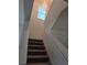 Staircase featuring neutral carpet, light-colored walls and trim, leading to upper level at 5962 Sw 80Th Ln, Ocala, FL 34476