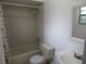Functional bathroom with tiled shower/tub combination, toilet, and vanity sink at 6141 Nw 64Th Ct, Ocala, FL 34482