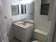 Bathroom featuring a single sink vanity with mirror, toilet, and window at 6141 Nw 64Th Ct, Ocala, FL 34482
