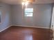 Bright bedroom with hardwood floors, ceiling fan, and a window providing natural light at 6141 Nw 64Th Ct, Ocala, FL 34482