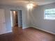 Spacious bedroom featuring hardwood floors, window, adjacent closet, and bathroom access at 6141 Nw 64Th Ct, Ocala, FL 34482