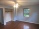 Cozy bedroom featuring a ceiling fan, window, and a convenient closet space at 6141 Nw 64Th Ct, Ocala, FL 34482