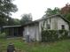 Exterior view of the home showing the backyard, screened in porch, and green grass at 6141 Nw 64Th Ct, Ocala, FL 34482
