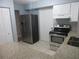 Modern kitchen with granite counters, stainless steel appliances, and white cabinets at 6141 Nw 64Th Ct, Ocala, FL 34482
