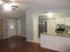 Inviting living room featuring hardwood floors, neutral paint, and a kitchen view at 6141 Nw 64Th Ct, Ocala, FL 34482