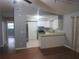 Cozy living space with wood floors, ceiling fan, and view of the modern kitchen at 6141 Nw 64Th Ct, Ocala, FL 34482