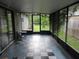 Screened porch with a black and white tiled floor and outdoor views at 6141 Nw 64Th Ct, Ocala, FL 34482