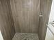 Modern shower with tiled walls, pebble floor and rainfall shower head at 6141 Nw 64Th Ct, Ocala, FL 34482