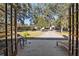 Backyard view featuring a patio, large trees, and an open garage at 7563 Nw 21St St, Ocala, FL 34482